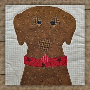 May include: A brown fabric dog with star and houndstooth patterns, wearing a red collar with star accents. The dog's eyes are made of houndstooth fabric. The background is a light beige fabric with a small white pattern.