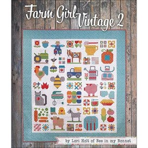 May include: A colorful quilt titled "Farm Girl Vintage 2" with a variety of farm-themed images, including a tractor, rooster, pig, and bee. The quilt has a light blue border and is set against a wooden background. The author's name is also visible.