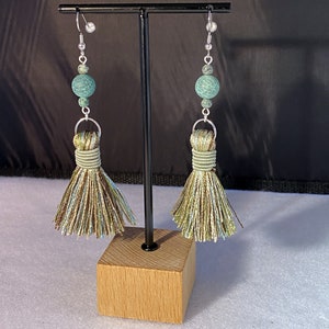 May include: A pair of green and brown tassel earrings with a green agate bead on each earring.