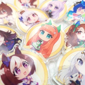 May include: A collection of circular acrylic charms featuring various anime-style characters with colorful hair and outfits. Each charm is set against a yellow circular background. The text "Chenna Kitty" and "chennakitty.com" is visible.