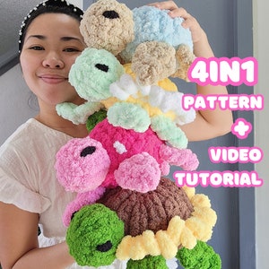 May include: A woman is holding a stack of four crocheted turtle amigurumi toys. The turtles are in different colours, including pink, green, blue, and brown. The text "4 IN 1 PATTERN + VIDEO TUTORIAL" is visible in the image.