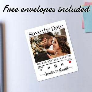 May include: A white save the date magnet with a photo of a couple in front of a floral backdrop. The magnet has a music player design with the text "Save the Date" and "We are getting married". The text "Jennifer & Russell" is at the bottom of the magnet.