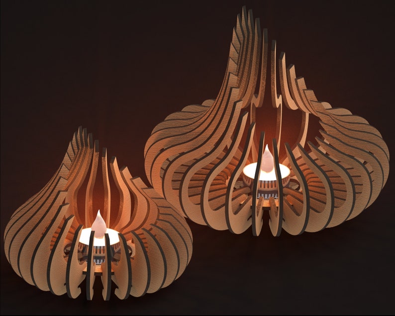 May include: Two wooden candle holders with intricate designs. Each holder features a small, round candle in the center, with the flames glowing brightly.