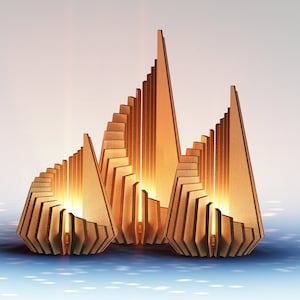 May include: Three wooden candle holders in the shape of abstract geometric structures. The candle holders are made of thin strips of wood that are stacked and interlocked to create a unique and modern design. The candle holders are lit and glowing, casting a warm and inviting light.