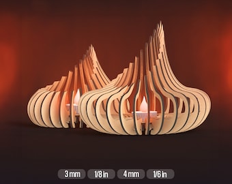 May include: Two wooden candle holders in the shape of a teardrop with intricate cutouts. The holders are made of light brown wood and have a natural finish. The candle holders are 3 mm thick and 1/8 in thick.