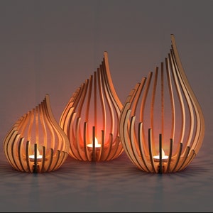 Digital laser cut files for a set of three wooden teardrop tealight holders, featuring curved slat design and glowing candles, perfect CNC pattern for home décor and gift projects.