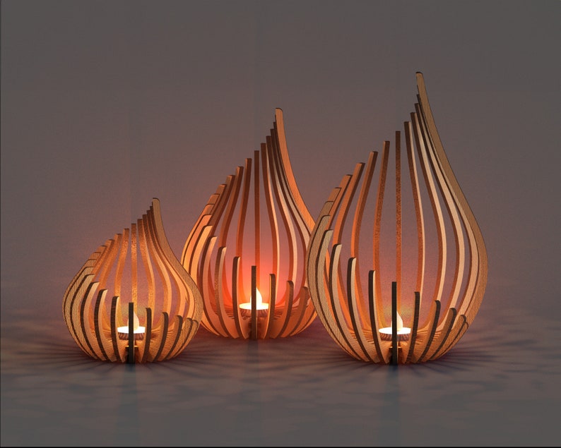 Digital laser cut files for a set of three wooden teardrop tealight holders, featuring curved slat design and glowing candles, perfect CNC pattern for home décor and gift projects.