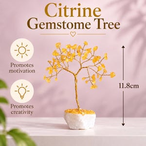 May include: A Citrine Gemstone Tree with yellow crystal leaves on gold wire branches, anchored in a white stone base. The text reads Citrine Gemstone Tree, Promotes motivation, Promotes creativity, and indicates a height of 11.8cm.