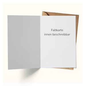 May include: An open, blank greeting card with a white interior and a gray left panel. The right panel has the text "Faltkarte innen beschreibbar" in black. The card is inside a brown envelope.