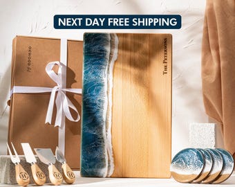 May include: A wooden cutting board with a blue and white resin wave design, personalized with "The Petersons." Includes a gift box, cheese knives, and coasters. The text "NEXT DAY FREE SHIPPING" is displayed at the top.