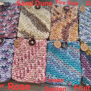 May include: Ten crocheted pot holders with different color patterns and wooden buttons. The pot holders are labeled with names like "Sunset", "Sand Dune", "Fire Side", "Dive In", "Lavender", "Rose", "Flower Garden", "Fruit Salad".