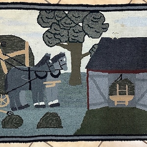 May include: Hand-hooked rug depicting a rural farm scene. The rug features a barn, windmill, and figures working with hay and horses. The color palette includes shades of green, blue, brown, and red, creating a rustic aesthetic.