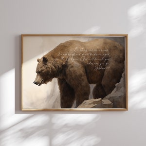 May include: A watercolor painting of a brown bear walking on a rocky cliff with a beige background. The painting includes a bible verse: "Be strong and courageous. Do not be afraid; do not be discouraged, for the Lord your God will be with you wherever you go. Joshua 1:9"