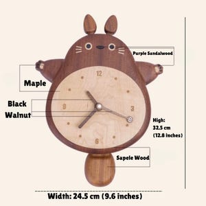 May include: A wooden wall clock shaped like a cartoon character with a pendulum. The clock face is made of maple wood and the body is made of black walnut, purple sandalwood, and sapele wood. The clock measures 12.8 inches high and 9.6 inches wide.