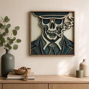 May include: A framed, layered wood art piece depicts a skull wearing a hat and suit, smoking a cigarette. The artwork features shades of blue, white, and tan, with a detailed, three-dimensional effect. The frame is a warm brown.