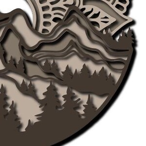 May include: A multi-layered circular wall art piece featuring a dark brown and beige mountain landscape with a forest of pine trees in the foreground and an intricate, mandala-inspired sun pattern at the top, all crafted with cut-out details.
