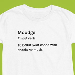 May include: White t-shirt with the word "Moodge" and its pronunciation, followed by the definition: "To boost your mood with snacks or music."