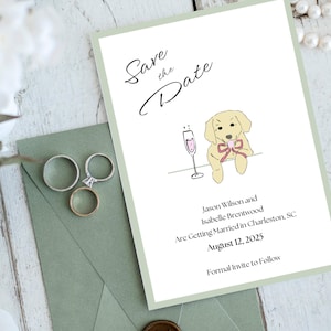 May include: A wedding invitation with a pale green border. It features the text "Save the Date" and a cartoon dog with a champagne glass. The invitation includes the names Jason Wilson and Isabelle Brentwood, the wedding date, and location.