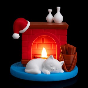 May include: A 3D-printed Christmas-themed candle holder featuring a red brick fireplace, a sleeping white cat, a Santa hat, and a small bucket of logs. The candle holder has a blue base and two white vases.
