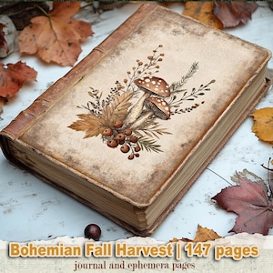 May include: A vintage-style journal with a weathered, tan cover featuring a central illustration of two spotted mushrooms, autumn leaves, berries, and sprigs. The text on the bottom reads Bohemian Fall Harvest | 147 pages journal and ephemera pages.
