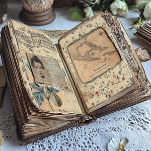 May include: An antique, leather-bound journal with aged pages and decorative elements. The journal is open to reveal a map of the West Indies Islands and a vintage photograph of a woman.