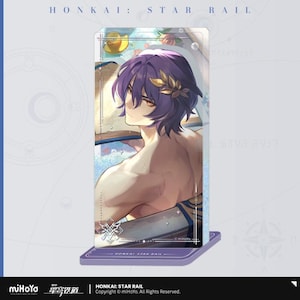 May include: A clear acrylic stand featuring a character illustration from Honkai: Star Rail. The character has purple hair and is adorned with a gold laurel. The stand is on a purple base with the game's logo and copyright information.