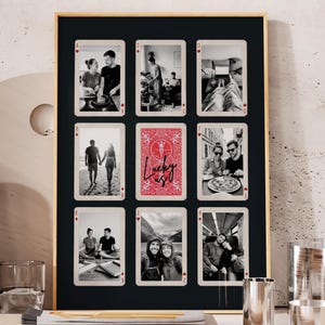 May include: A framed collage featuring nine playing card-style photo displays. The central card is red with the word "Lucky" in white script. The other cards display black and white photos of people.