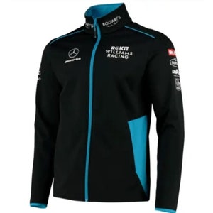 Może przedstawiać: Czarna kurtka z turkusowymi akcentami, z logo "ROKiT Williams Racing" i emblematami sponsorów. Kurtka ma stójkę z napisem "BOGART'S" i zamek błyskawiczny na całej długości. Widoczne jest również logo Mercedes-AMG.
