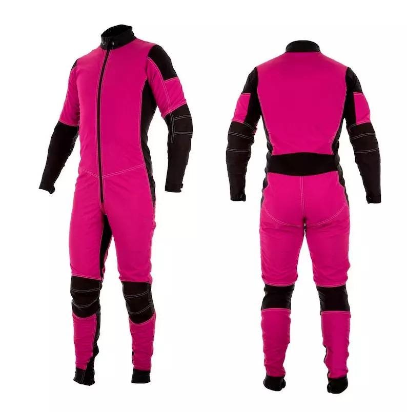 May include: A pink and black jumpsuit with a zip at the front. The jumpsuit has black accents on the shoulders, arms, and legs.