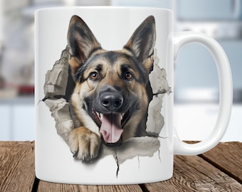 May include: White ceramic mug featuring a German Shepherd dog bursting through a wall. The dog has brown and black fur, a pink tongue, and appears to be smiling. The mug has a white handle and is set against a blurred background.