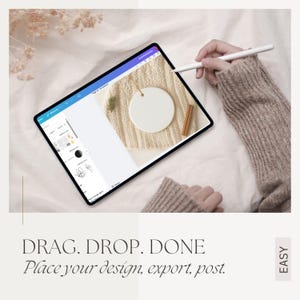 May include: A digital tablet displaying a design interface with a blank white ornament. The tablet is on a cream-colored knitted surface with a sprig of greenery and a cinnamon stick. Text reads: DRAG. DROP. DONE. Place your design, export, post.