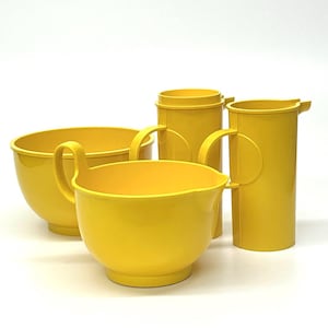 May include: A set of four bright yellow kitchen mixing bowls and measuring cups. The bowls and cups have handles and a smooth, glossy finish. The set includes a large bowl, a medium bowl, and two measuring cups.