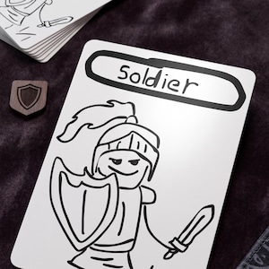 May include: A white rectangular playing card featuring a black line drawing of a soldier wearing a helmet, holding a shield and a sword. The word Soldier is printed in black text inside a rounded rectangular border at the top of the card.