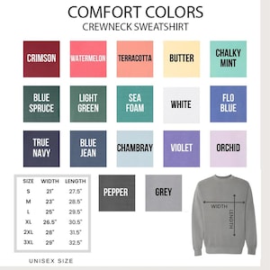 May include: A chart showing the color options for a crewneck sweatshirt. The colors are displayed in a grid with the names of each color listed below. The chart also includes a size chart with measurements in inches for width and length. The sweatshirt is shown in a light grey color with a size chart on the sleeve.