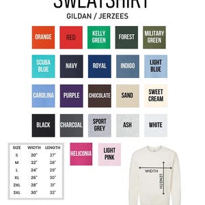 May include: A chart showing the different colours and sizes available for a Gildan/Jerzees sweatshirt. The chart includes colours like orange, red, kelly green, forest, military green, scuba blue, navy, royal, indigo, light blue, carolina, purple, chocolate, sand, sweet cream, black, charcoal, sport grey, ash, and white. The chart also includes sizes S, M, L, XL, 2XL, and 3XL with corresponding width and length measurements in inches. A white sweatshirt is shown with a diagram of width and length measurements.
