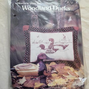 May include: A pillow kit by Yours Truly, titled "Woodland Ducks." The kit includes fabric and instructions to create a pillow with a duck design. The finished pillow size is approximately 15" x 19" (38.1cm x 48.3cm).