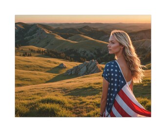 May include: A woman stands on a grassy hilltop, looking out at a rolling landscape. She is wearing a white tank top and a red, white, and blue American flag draped over her shoulders.