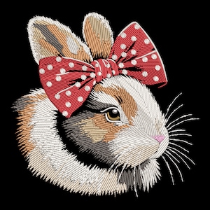 May include: Embroidered design of a brown and white rabbit wearing a red bow with white polka dots.