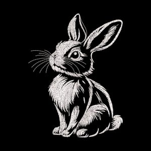 Puede incluir: Diseño de conejo bordado en blanco sobre fondo negro. El conejo está representado sentado, con largas orejas y textura de pelaje detallada. Adecuado para proyectos de bordado y manualidades.