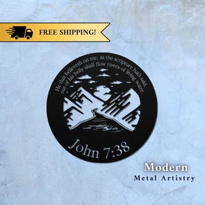 May include: Black metal wall art featuring a mountain scene and the text "He that believeth on me, as the scripture hath said, out of his belly shall flow rivers of living water. John 7:38".