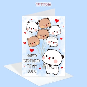 May include: A greeting card with a blue background and a panda holding a bunch of balloons. The balloons are shaped like pandas and bears. The card says "Happy Birthday to my Dudu".
