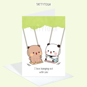May include: A greeting card with a green background featuring two cartoon animals, a brown bear and a black and white panda, on a swing. The text on the card reads "I love hanging out with you".