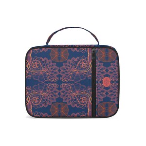 May include: A rectangular lunch bag with a handle, featuring a repeating floral pattern in orange and pink on a navy blue background. The bag has a black zipper and a small circular logo.