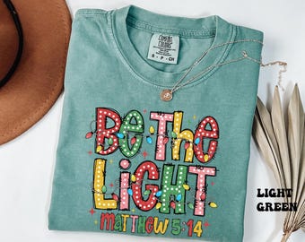Comfort Colors® Be The Light Christmas Shirt, Religious Christmas Shirt, Christian Christmas Gifts, Christian Holiday Tee, Bible Verse Shirt