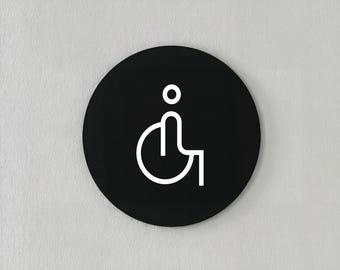 Modern minimalist acrylic black and white sign for disabled persons, circular design.