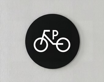 Modern minimalist acrylic black and white bicycle parking sign, circular design.