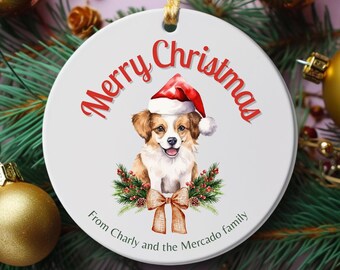 May include: White ceramic Christmas ornament with a watercolor illustration of a dog wearing a Santa hat. The ornament has the words "Merry Christmas" in red script and a message from "Charly and the Mercado family".
