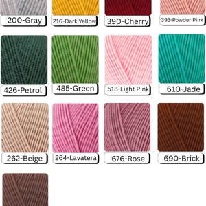 May include: A collection of yarn skeins in various colors, including gray, dark yellow, cherry red, powder pink, petrol, green, light pink, jade, beige, lavatera, rose, brick, and brown. Each skein is labeled with a color name and number.