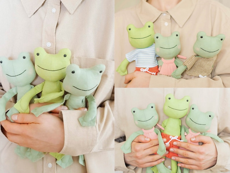 May include: Three green frog plush toys with embroidered faces and different outfits. The frogs are being held by a person's hands.
