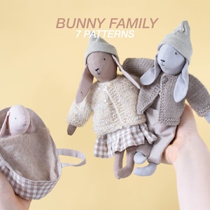 May include: A set of three plush bunny toys, two wearing knitted sweaters and hats, and one in a gingham-patterned tote bag. The caption reads "Bunny Family 7 Patterns".